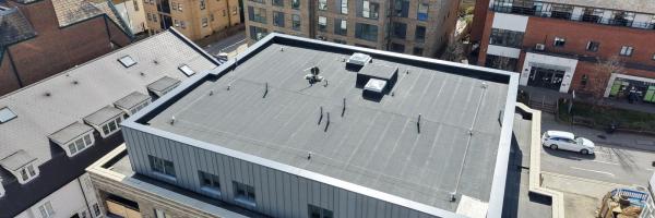 Bath Store, Tonbridge Road, Maidstone — aerial view showing completed main roof with MOY Imper Paralon ARD/HS Plus charcoal grey capsheet and SFS horizontal lifeline system