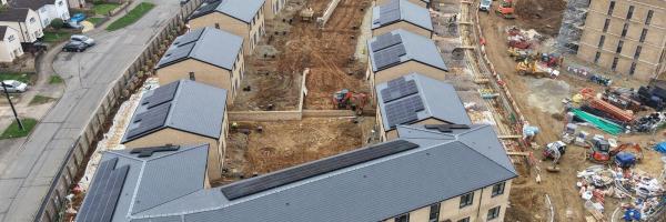 Aerial overview – Cambridge Crescent Phase 1, Maidstone. Pitched roofs in Cambrian Roof Tiles visible across the houses and apartment block foreground.