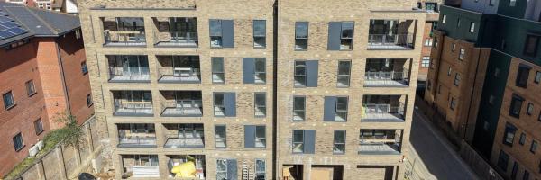 Corbens Place – south elevation showing completed balconies across all four floors (March 2026)