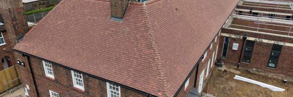 Aerial view of the completed main building showing Marley Plain Tiles, hipped ends and original chimney stacks.