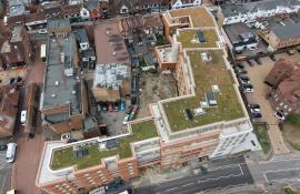 High aerial view of the completed green roofs at Purelake Sevenoaks with the town centre beyond