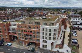 Elevated view of the completed Purelake Sevenoaks building from the road with green roof visible