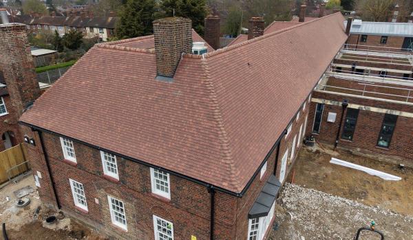 Aerial view of the completed main building showing Marley Plain Tiles, hipped ends and original chimney stacks.