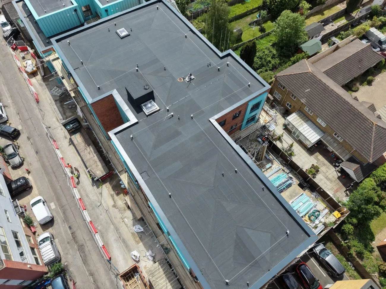 Block GG lower roofs — lifeline posts visible